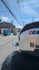 Motorcycle rider travels through sunny Davao City streets