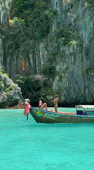 Boats and limestone cliffs in Ao Nang's turquoise waters