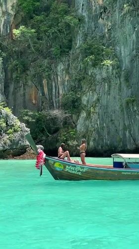 Boats and limestone cliffs in Ao Nang's turquoise waters