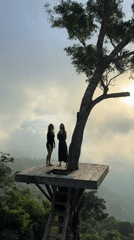 Two women visit mountain tree platform in Abang, Indonesia