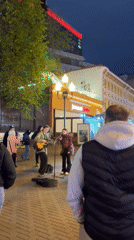 Evening park scenes feature illuminated walkways and traditional food stall