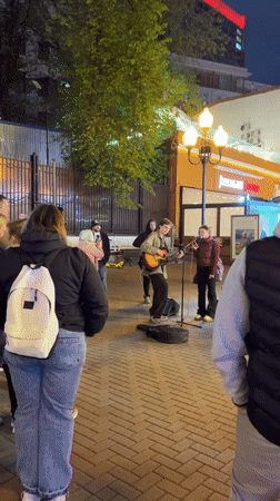 Evening park scenes feature illuminated walkways and traditional food stall
