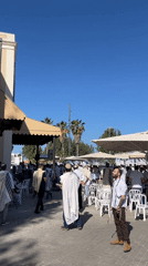 Men gather in Tel-Aviv public square on sunny morning