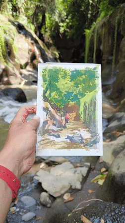 Artist paints watercolor studies of jungle stream in Sukawati