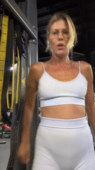 Woman exercises and stretches at gym in Mengwi