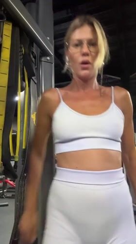 Woman exercises and stretches at gym in Mengwi