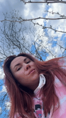 Woman poses outdoors in pink outfit in Черёмушки, Russia