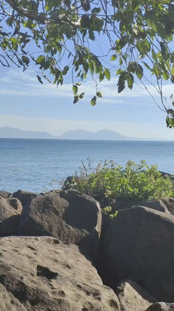 Visitor documents peaceful morning coastal scenes in Banda Aceh