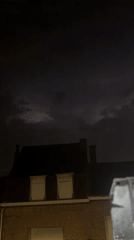 Stormy night in Wattrelos: cat, trading cards, and lightning