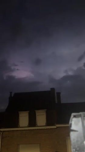 Stormy night in Wattrelos: cat, trading cards, and lightning