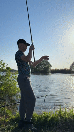Man catches fish during afternoon fishing session in Elovo, Russia