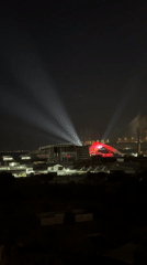 Illuminated bridge displays white and red lights in Loures nightscape