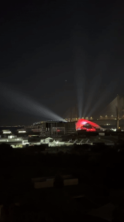 Illuminated bridge displays white and red lights in Loures nightscape