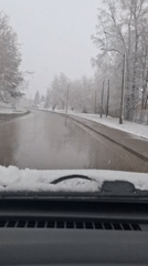 Spring snow observed from vehicle in Russian town