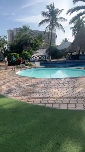 Tourist documents resort visit with selfies in Porlamar, Venezuela