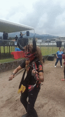 Masked violinist performs with band at outdoor Quito event