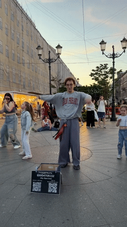 Street dancers draw a crowd on Nevsky Prospekt at midsummer dusk