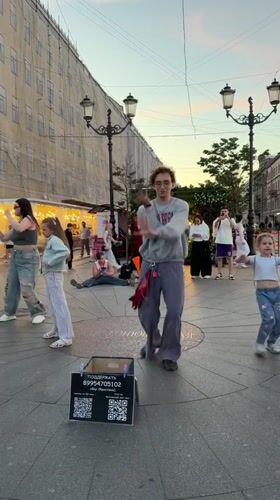 Street dancers draw a crowd on Nevsky Prospekt at midsummer dusk