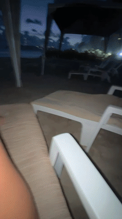 Woman enjoys late-night dining and beach drinks in Acapulco
