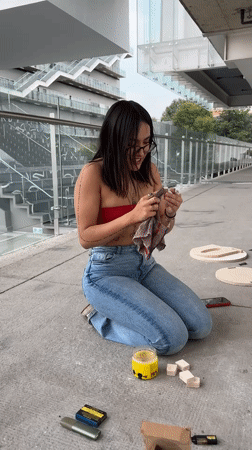 Women craft wooden objects on Mexico City rooftop terrace