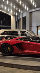 Red Lamborghini parked outside lit-up Batumi venue at night
