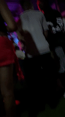 Person dances in red skirt at nightclub venue