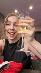 Woman enjoys wine and crocheting at home in Krasnoyarsk