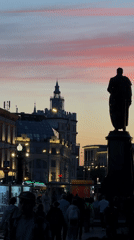 Pink sunset illuminates Moscow square and statue at dusk