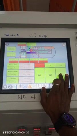 A close-up shot shows a person's hand interacting with a touchscreen control panel on a machine. The panel displays a schematic diagram of a process, with various labeled components and adjustable parameters. The hand touches different buttons and numerical fields on the screen, likely adjusting settings or monitoring performance. The person is wearing a smart watch on their wrist. Labels near the screen read "350ml wine" and "U1 01-03". There's also a handwritten note "NO: 4" and a "TECNO CAMON 20" watermark at the bottom. The surrounding environment appears to be an industrial setting.
