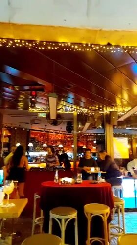 Cozy Sofia bar, string lights and red tablecloths