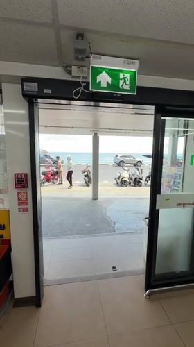 Slow morning on Patong Beach — surf, rocks, and a 7-Eleven run