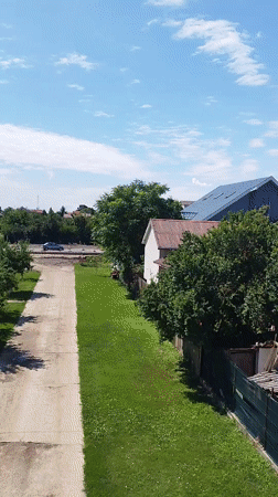 Quiet summer morning across a Bucharest residential neighborhood
