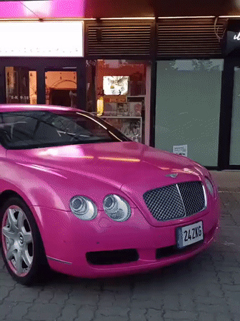 Pink Bentley parked outside neon-lit Tallinn boutique