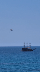 Parasailing and beach activities on calm ocean waters
