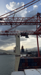 Maritime operations observed: container loading, motorboat transit