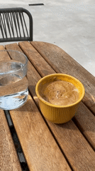 Woman enjoys morning coffee at Tivat waterfront establishment