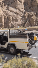 Motorcycles loaded onto a truck on a remote Himalayan road