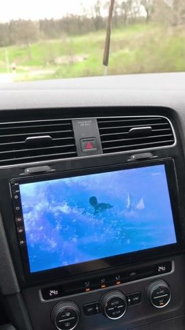 The video shows a first-person perspective of driving a car on a road, the speedometer indicates 61 km/h, the dashboard displays other information, the interior of the car is visible, including the steering wheel and center console, and the car is moving through a landscape with trees on both sides of the road.