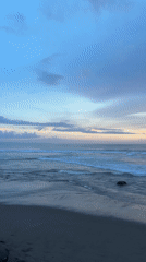 Dawn beach scene captured with colorful sky display