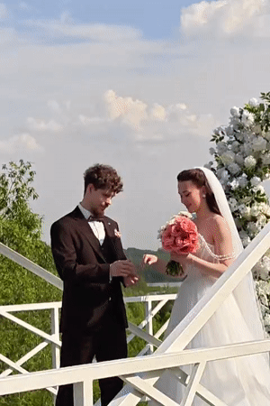 Wedding ceremony takes place on wooden bridge in Khimki