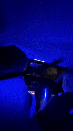 Person installs colorful LED lights in car interior, Bulgaria
