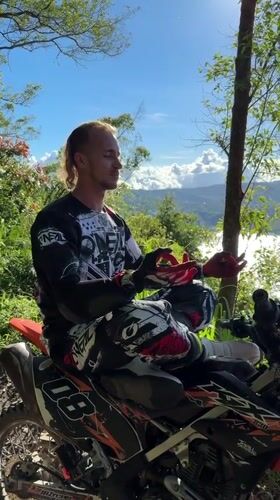 Motocross rider takes scenic break on Kintamani hillside