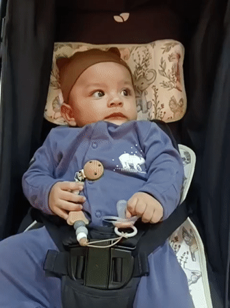 Baby in stroller, cared for during outing near Mesjid Reuntoh