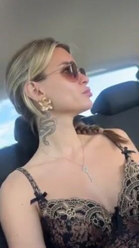 Woman with distinctive styling observed in car backseat, San Isidro
