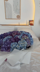 Bedroom decorated with hydrangea bouquet for celebration in Ubud