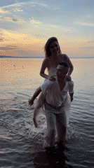 Sunset wading in white at the Chaikovsky waterfront