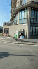 Two people gather on sunny Milano street corner