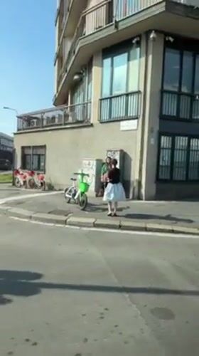 Two people gather on sunny Milano street corner
