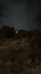 Glimpse of a lit tower through Yerevan's night from a moving vehicle