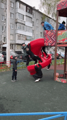 Children play at Ufa playground on overcast day
